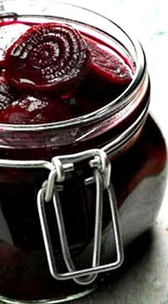 a jar filled with red liquid sitting on top of a table