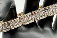 "This is a beautiful Victoria Wieck 20 carat tennis bracelet. This is a strong quality made bracelet. It was purchased from QVC and the original price was $600. I purchased it from an estate. Each hinged link of this elegant tennis bracelet is tiled in channels of Absolute simulated diamonds. It is called a bridge design bracelet because if you look at it from the side, it looks like a bridge. The stones are set in a durable gold vermeil over Sterling Silver.  This bracelet has two safety catche Diamonds Bracelet, Cz Bracelet, Design Bracelet, Bridge Design, Wedding Jewelry Bracelets, A Bridge, Wedding Bracelet, Tennis Bracelet, Bracelet Designs