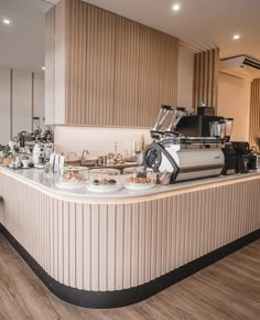 a coffee shop counter with lots of cups and saucers on it's sides