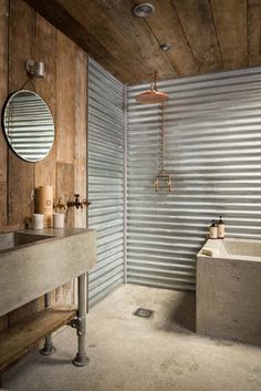 a bathroom with a sink, mirror and shower stall in the middle of the room