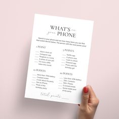 a person holding up a printable what's on the phone