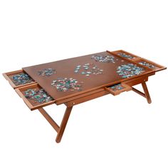 a wooden table with two trays on it and one is filled with puzzle pieces