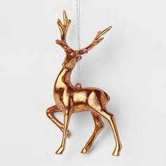 an ornament shaped like a deer hanging from a chain