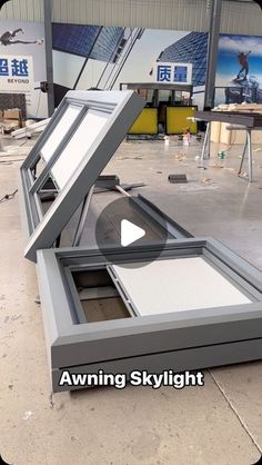 an airport baggage claim machine with its lid open and the words awning skylight in front of it