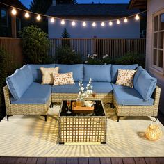 an outdoor patio with blue couches and lights