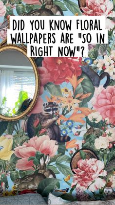 there is a mirror on the wall in front of a flowered wallpaper with birds and flowers