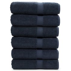 six towels stacked on top of each other in dark blue color, with one folded and the