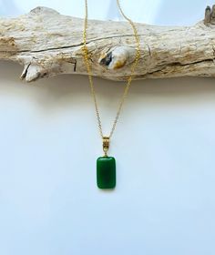 A piece of charming & elegant dark square green jade pendant necklace, which is made with genuine 100% natural real green jade cube and 18k gold plated necklace. A great combination of modernness and vintage styles. The simple and minimalistic gold color design adds a spark to your daily wear or a bit of charm for your date night. Perfect as a gift for your loved ones or just treat yourself. Some Highlights of this dark green genuine jade circle pendant are: ＊High-quality Material Only Made from quality Chinese green square jade paired with solid 925 sterling silver, plated with 18k gold. Ensures long-lasting and is great for sensitive skin. ＊Simple & Elegant Design A simple and classy jade cube pendant makes great decor for all sorts of occasions. subtle but eye-catching. ＊Measurements: T Elegant Rectangular Jade Necklace, Rectangular Jade Gemstone Necklaces, Rectangular Jade Gemstone Necklace, Minimalist Green Emerald Necklaces, Minimalist Green Necklaces For Jewelry Making, Minimalist Gold Jade Jewelry, Rectangular Green Gemstone Jewelry, Elegant Green Rectangular Necklaces, Elegant Green Rectangular Emerald Necklace