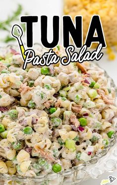 tuna pasta salad in a glass bowl with the words tuna pasta salad on top and below