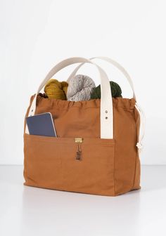 Originally designed and sold by Fringe Supply Co., the Town bag is a great everyday purse and/or a do-it-all project bag, no matter what your project may be. It has the same drawstring closure and interior pockets – designed for corralling tools, patterns, and miscellany – as the Field bag (minus the grommets), but wit Field Bag, Grainline Studio, Everyday Purse, Project Bag, Marking Tools, Large Bag, Needle And Thread, The Field, Bag Pattern