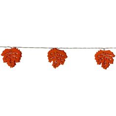 three red leaves are hanging on a string