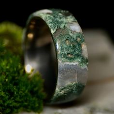 a ring with green moss growing on it