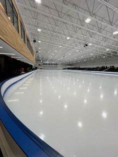 an indoor skating rink with lights on the ceiling