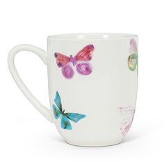 a white coffee cup with colorful butterflies on it