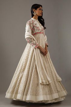 Ivory long sleeves mandarin collar neck flared anarkali with dahlia bloom flora and banasai jaal embroidery. Paired with churidar and seer sucker detail dupatta.
Components: 3
Pattern: Embroidery
Type Of Work: Dahlia Bloom Flora
Neckline: Mandarin Collar
Sleeve Type: Long
Fabric: Silk Chanderi, Lining: Cotton
Color: Ivory
Other Details: 
Note: The cancan skirt worn by the model is not for sale
Occasion: Sangeet, Mehendi and Haldi - Aza Fashions White Anarkali Gown For Diwali, Festive White Anarkali Gown, Traditional Off White Anarkali Set With Intricate Embroidery, Traditional Off-white Anarkali Set With Intricate Embroidery, White Unstitched Traditional Gown, White Lehenga With Resham Embroidery And Long Sleeves, White Anarkali Gown For Navratri, White Saree Shaped Gown For Transitional Season, White Saree Gown For Transitional Season