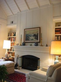 a living room filled with furniture and a fire place in front of a book shelf