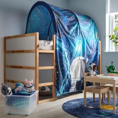 a child's room decorated in blue and white with an animal themed tent on the wall