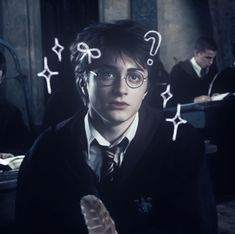 harry potter with question marks drawn on his face in front of him and others sitting at desks