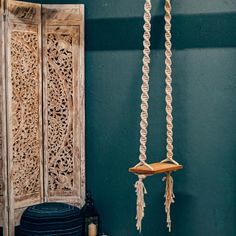 a blue room with an old wooden door and some tassels hanging from it