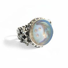 The subject of this ring is the moon and stars expressed in iridescent aurora satin glass. Light moves through the glass every way you position your hand, opalescent and glowing in soft hues of blue, purple, aqua, peach and lavender. It is surrounded by an aurora crystal border with three carved stars on both sides which join it to the ring shank, a tapering, comfortable pierced band that may be adjusted to fit sizes 6 through 9. Choice of metal finish in burnished bronze or antique silver. Made Aurora Borealis Jewelry, Stars Ring, Stars Jewelry, Ring Moon, Crescent Moon Ring, Mood Ring, Antique Ring, Moon Ring, Sweet Romance