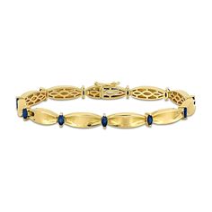 This stunning blue sapphire and 10K gold bracelet will add a touch of elegance to any outfit. 10K gold. Bracelet features solid cinched oval-shaped links joined by 4 x 2.0mm marquise-cut blue sapphire stations. 7.25-inch bracelet secures with a box clasp. Navy And Gold Jewelry, Classic Sapphire Bracelets For Anniversary, Classic Yellow Gold Bracelet With Gemstone, Yellow Gold Sapphire Jubilee Bracelets, Yellow Gold Sapphire Tennis Bracelet For Formal, Yellow Gold Sapphire Tennis Bracelet For Formal Occasions, Elegant Blue Diamond Bracelet In 14k Gold, Formal Sapphire Tennis Bracelet In Yellow Gold, Elegant Gold Sapphire Bracelets