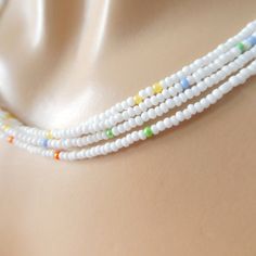 "Unique white necklace with a sprinkle of color in it. Please see pictures and note this is not plain white. It as some color beads throughout, but is is a great accessory if you want something understated and subtle. The size shown in the picture is 16\". Please read specifications on SIZES below: ❤ SIZES This item comes in several sizes, kindly choose at checkout. The easiest way to find out which length suits you best is to measure a necklace you already own, from one end to the next, includi White Dainty Necklace With Spacer Beads, White Dainty Beaded Chain Necklace, Dainty White Necklace With Spacer Beads, White Dainty Beaded Necklace, Delicate White Beaded Necklaces, Delicate White Beaded Chain Necklace, Dainty White Beaded Necklaces, Delicate White Beaded Necklaces With Tiny Beads, White Beaded Chain Dainty Jewelry