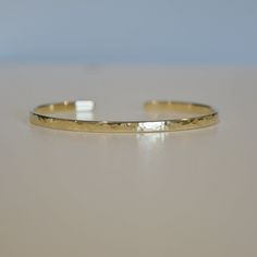 Send some encouragement with this inspiring gold plated cuff bracelet. - 22K Gold plated bracelet engraved with your chosen message. - The  thickness of gold plating is around 0.5 microns (it's sufficient even for jewelry pieces that are exposed to rough wear) - Text, coordinates, numbers outside or inside the cuff  - Up to 90 characters  on each side - Approximately 3mm wide, 6.3'' standard women size, 7'' standard men size - If you need both sides engraving, please contact me before purchase Adjustable Etched Gold Cuff Bracelet, Adjustable Etched Bangle Bracelets, Adjustable Gold Bangle With Stamped Details, Gold Adjustable Stamped Cuff Bracelet, Adjustable Gold Stamped Cuff Bracelet, Adjustable Stamped Gold Cuff Bracelet, Adjustable Hammered Everyday Bracelets, Adjustable Tarnish Resistant Bangle, Adjustable Etched Bracelets For Anniversary