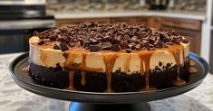 a cake with chocolate and caramel drizzles on it sitting on a plate