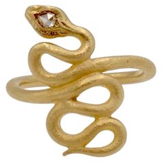 This snake ring is fun and fanciful. It has a 0.05 carat rose cut diamond in the head that has a beautiful sparkle offset by the matte finish of the yellow gold. The shape of the snake is elegant on the finger and is comfortable to wear. A beautiful example of nature inspired jewelry! It is a size 6 1/4 and can be sized to fit. Gold Snake Ring With Single Cut Diamonds, Diamond Snake Ring As Gift, Snake-shaped Diamond Ring Gift, Snake-shaped Diamond Rings For Gifts, Diamond Snake Ring With Single Cut Diamonds As Gift, Ancient Rings, Serpent Jewelry, Tibetan Jewelry, Women's Rings