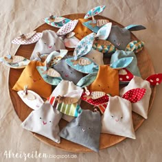 a wooden plate topped with lots of different types of fabric