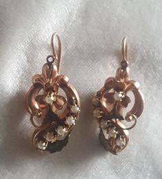 These earrings are a beautiful rose gold. They have been tested to gold of 14k.  They have a European touchmark on the ear backs but I cannot make them out. The earrings are ornate with a clover center,  swirls and textured leaves. Each earring has 6 claw set natural pearls. The thing to consider with these is that the earrings are mirror images of each other, something that looks a small touch but very labour intensive to do. These are masterfully done. C. 1880 and Continental 3.6 grams. Follow me on instagram@jettesjewels. Elegant Rose Gold Filigree Earrings, Victorian Style Hallmarked Earrings For Formal Occasions, Anniversary Rose Gold Earrings With Lever Back, Formal Victorian Hallmarked Earrings, Victorian Pearl Earrings For Anniversary, Elegant Flower Earrings With Lever Back For Anniversary, Rose Gold Pierced Earrings For Evening, Victorian Bridal Earrings For Anniversary, Elegant Drop Earrings With Screw Back