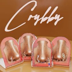 three pairs of jewelry sitting on top of each other in front of a sign that says coiffy