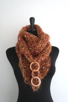 This elegant and sumptuous kerchief is a true fashion statement and is sure to draw attention. You can wear it in so many ways. Just look at the pictures to get some ideas. I knitted this mini shawl from a soft mohair acrylic yarn and embellished with wooden rings. More scarves - https://www.etsy.com/shop/KnitsomeStudio?section_id=6751131 More shawls - https://www.etsy.com/shop/KnitsomeStudio?section_id=6598836 Don't forget to check out my other items! There are many more in my shop -- https://w Brown Bohemian Scarves One Size, Brown Shawl Scarf One Size, Handmade Elegant Scarves One Size, One-size Brown Shawl, Brown Shawl Scarf, Handmade Brown Shawl Scarf, Brown Winter Scarves For Gifts, Brown Winter Scarves For Gift, Handmade Brown Scarves For Gifts