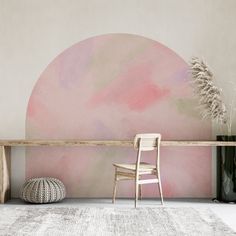 a chair sitting on top of a rug next to a wooden table and vases