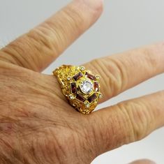 Mans Beautiful 18k Gold Plated Millionaires Ring. Centered Is A Full Cut Handplaced Aa Graded Cz Solitaire Surrounded With Bagette Cut Ruby Color Crystals. Small Cz's Are Placed Randomly To Complete This One Of A Kind Look. Diamond Jeweled Rings For Anniversary, Jeweled Diamond Ring For Anniversary, Anniversary Cubic Zirconia Jeweled Rings, Formal Jeweled Diamond Rings, Diamond Rings With Jeweled Details, Diamond Jeweled Rings, Jeweled Diamond Rings, Formal Fine Jewelry Jeweled Rings, Mans Ring