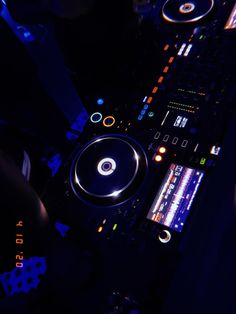 a dj mixing music at a party in the dark