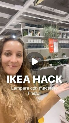 a woman is holding out her hand in front of shelves with plants and herbs on them