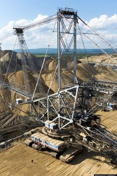 an aerial view of a construction site in the middle of nowhere, with trucks and machinery