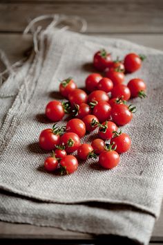 several small tomatoes on a linen bag