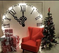 a red chair sitting in front of a large clock