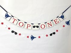 a banner that says top one with red, white and blue stars hanging from it