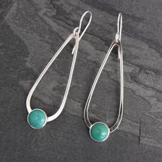 "Natural Turquoise teardrop dangle earrings. 8mm turquoise cabochons are set in sterling silver on handmade sterling silver teardrops. The teardrops swing from solid sterling silver ear wires. These earrings are 2.25 inches long including the ear wires. 5/8\" at the widest point. 8mm turquoise cabochons. For more earrings: https://www.etsy.com/shop/KiraFerrer?ref=hdr_shop_menu&section_id=7937255 You may also like: https://www.etsy.com/shop/KiraFerrer?ref=hdr_shop_menu" Modern Turquoise Dangle Jewelry, Modern Turquoise Hypoallergenic Jewelry, Modern Teardrop Turquoise Jewelry, Elegant Turquoise Teardrop Earrings As Gift, Turquoise Cabochon Dangle Jewelry, Elegant Everyday Turquoise Earrings, Turquoise Teardrop Drop Earrings, Minimalist Natural Stone Teardrop Earrings, Elegant Handmade Turquoise Teardrop Earrings