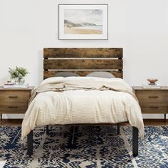 a bed sitting in a bedroom next to a wooden headboard and night stand on top of a rug