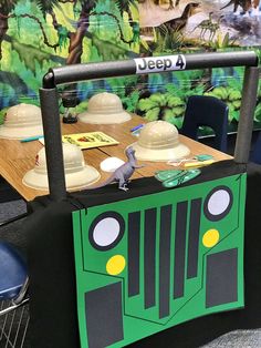 a table that has some kind of truck on top of it with hats on it