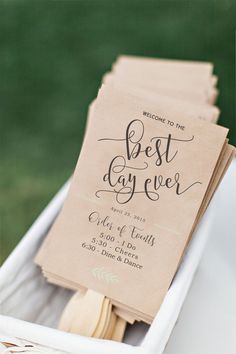 the wedding program is in a box with wooden utensils and paper napkins