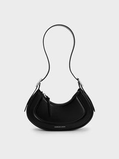 This product is made with at least 20% sustainable materials by weight. CHARLES & KEITH uses recycled, degradable, organic, and water-based materials in our eco-conscious collection. The Petra bag in sleek black is a classic piece that will effortlessly complement your existing wardrobe. Featuring a clean curved silhouette and a thick adjustable shoulder strap, this bag will sit comfortably on your shoulder - you can also choose to tucked under your arm. The main compartment offers ample space to hold your most-used essentials while the zip closure keeps them securely in place. Charles Keith, Eco Conscious, Sustainable Materials, Shoulder Strap, Sleek, Shoulder Bag, Wardrobe, Handbags, Water