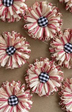 several red and white plaid fabric flowers on brown paper