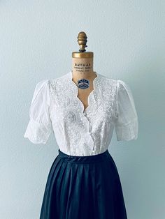 "This is a gorgeous women's white short sleeve, fitted embroidered cotton eyelet blouse. This has a button-down bodice and charming sleeves! +Not part of the wholesale deal+ I have a limited amount of these; they were from a theater company that closed in the 90s.   Please use my measurements to guide you; all sales are final. The measurements were taken with the shirt lying flat.  ✂ - - - Measurements Length- Approx. 23-1/2\" Laying flat measuring from the shoulder down to the hem Bust- will fi 1920s Blouse, Edwardian Shirt, Cottagecore Blouse, White Embroidered Blouse, Edwardian Wedding, Victorian Blouse, White Cotton Blouse, Lace Trim Blouse, Eyelet Blouse