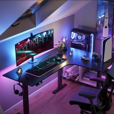 a computer desk with a monitor, keyboard and mouse on it in front of a purple light