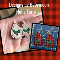 a hand is holding two christmas themed earrings with holly leaves on them and the words, designs by babymoon holly earrings